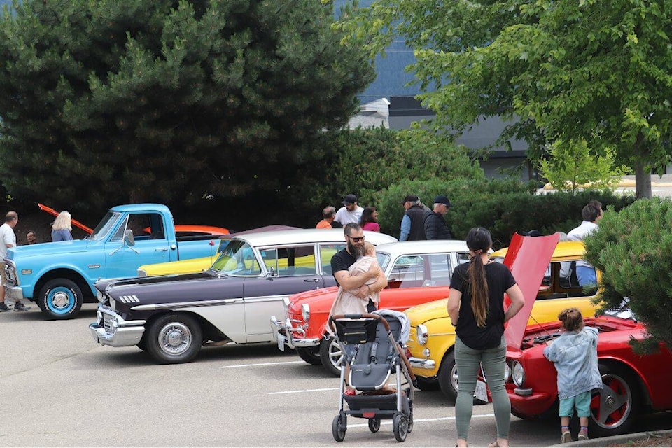 Vernonites check out the 105 cars on display at the annual North Okanagan’s Vintage Car Club Fathers Day Car Show, hosted at the Village Green Mall parking lot on Sunday, June 18. (Bowen Assman Photo)