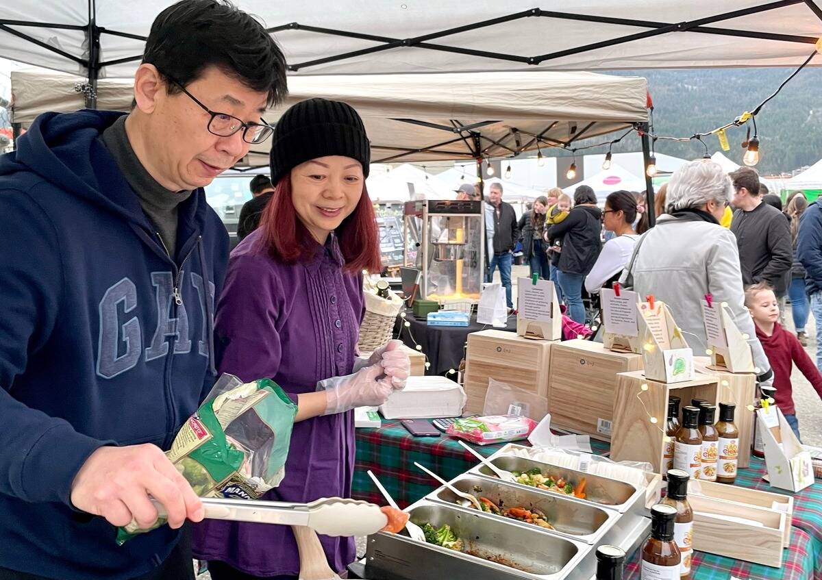 Charles Ouyang and Ann Liu cook up and serve samples using thier own stir-fry sauces at the Zest Commercial Food Hubs Zestfest. (Ann Liu/Contributed to Black Press Media)