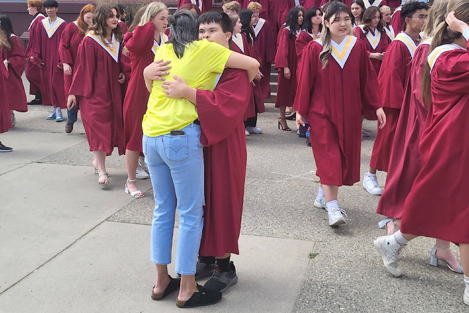 Clarence Fulton Secondary Class of 2023 graduate Taylor Cotter gets a hug from mom Bobbi Cotter at the official class photo Wednesday, June 21. (Roger Knox - Morning Star)