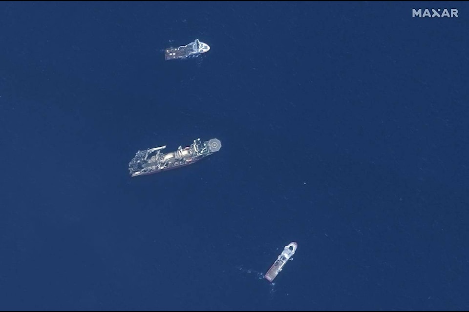 In this satellite image provided by Maxar Technologies, from top to bottom, the vessels Horizon Arctic, Deep Energy and Skandi Vinland search for the missing submersible Titan, Thursday, June 22, 2023 in the Atlantic Ocean. (Satellite image ©2023 Maxar Technologies via AP)