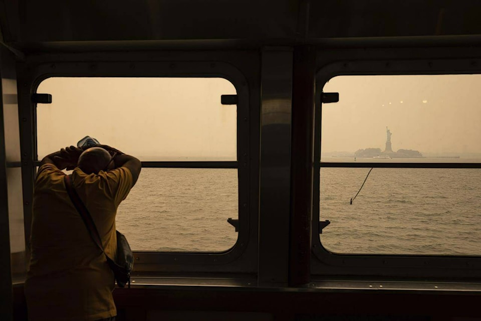 FILE - The Statue of Liberty, covered in a haze-filled sky, is photographed from the Staten Island Ferry, June 7, 2023, in New York. As smoky as the summer has been so far, scientists say it will likely be worse in future years because of climate change. (AP Photo/Yuki Iwamura, File)