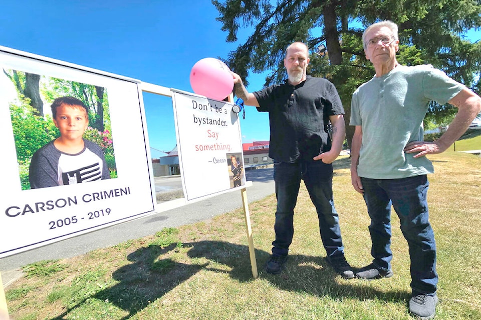 On what would have been Carson Crimeni’s 18th birthday, July 2, his father Aaron (centre) and grandfather Darrel (right) went to the skateboard park in Walnut Grove and put up a sign. (Dan Ferguson/Langley Advance Times)