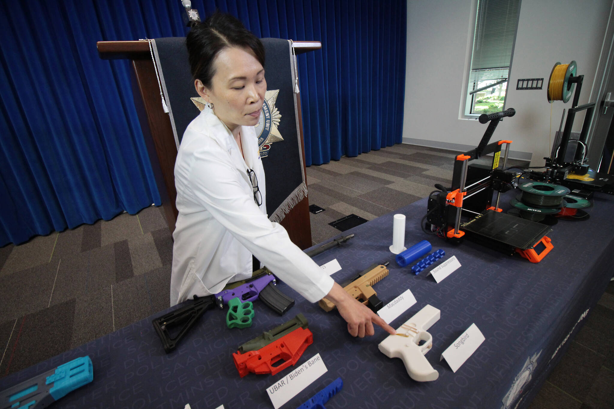 The Combined Forces Special Enforcement Unit Provincial Forensic Firearms Lab manager Daisy Wong points to a Songbird firearm, which was almost entirely made from a 3D printer. The CFSEU-B.C. warned the public, parents and their children of the dangers of using 3D printers to make firearms or other potential weapons during a press briefing Tuesday (July 11, 2023). (Lauren Collins)