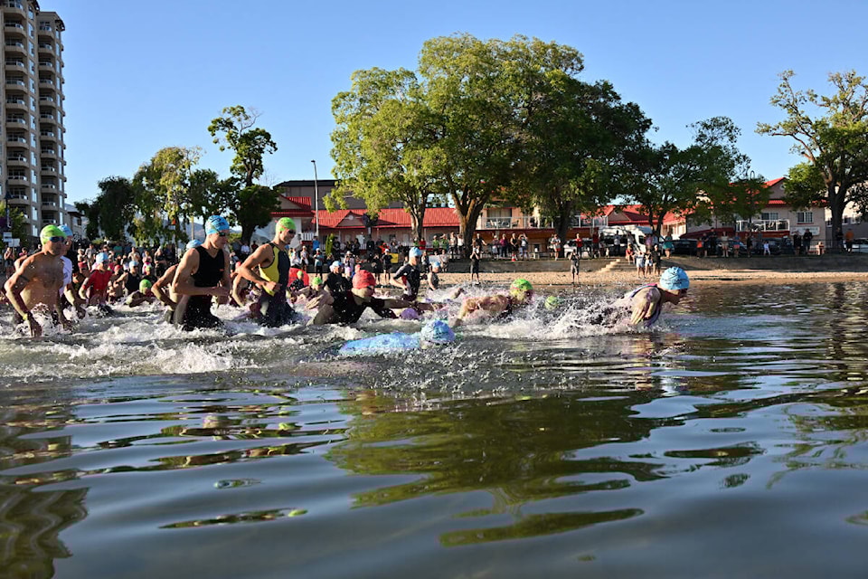 And they are off: Peach Classic athletes dive into Okanagan Lake by the Peach for a 1.5 km swim. (Brennan Phillips Western News)
