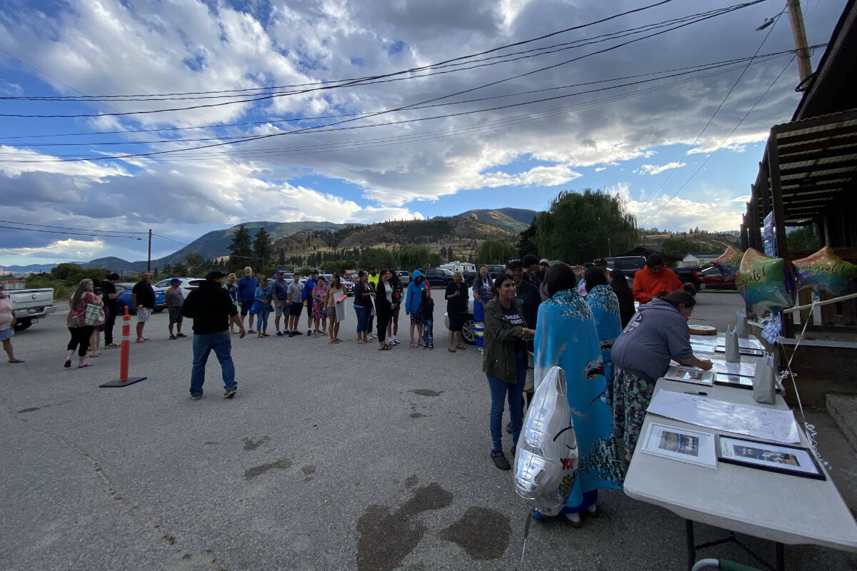 Community members wait to shake hands with the gold-medal-winning athletes at the Penticton Indian Band Hall on July 25.