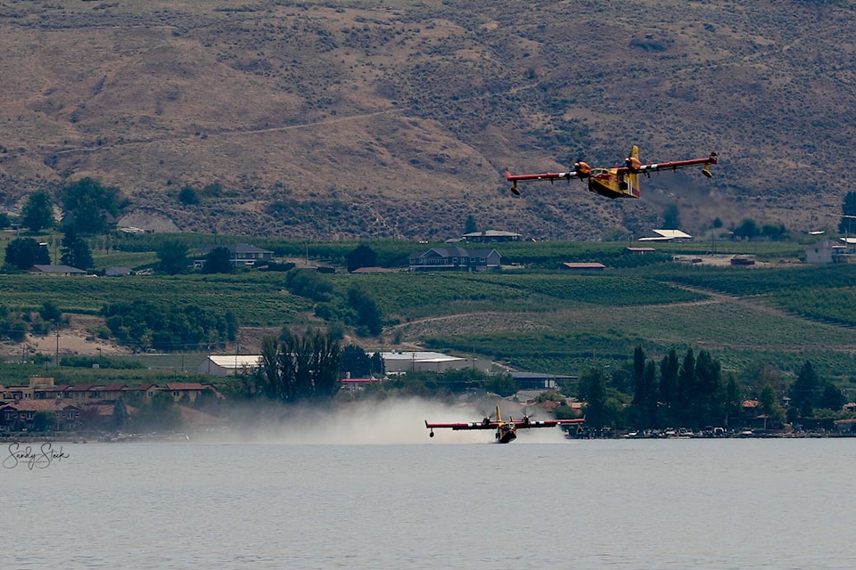 Air crews reload their water tanks on Osoyoos Lake while fighting the Eagle Bluff Wildfire on July 30. The air tankers worked tireless on the fire as did many contributing firefighters on Sunday. The wildfire remained out of control on July 31, though many evacuation orders had been lifted. (Sandy Steck - Contributed)