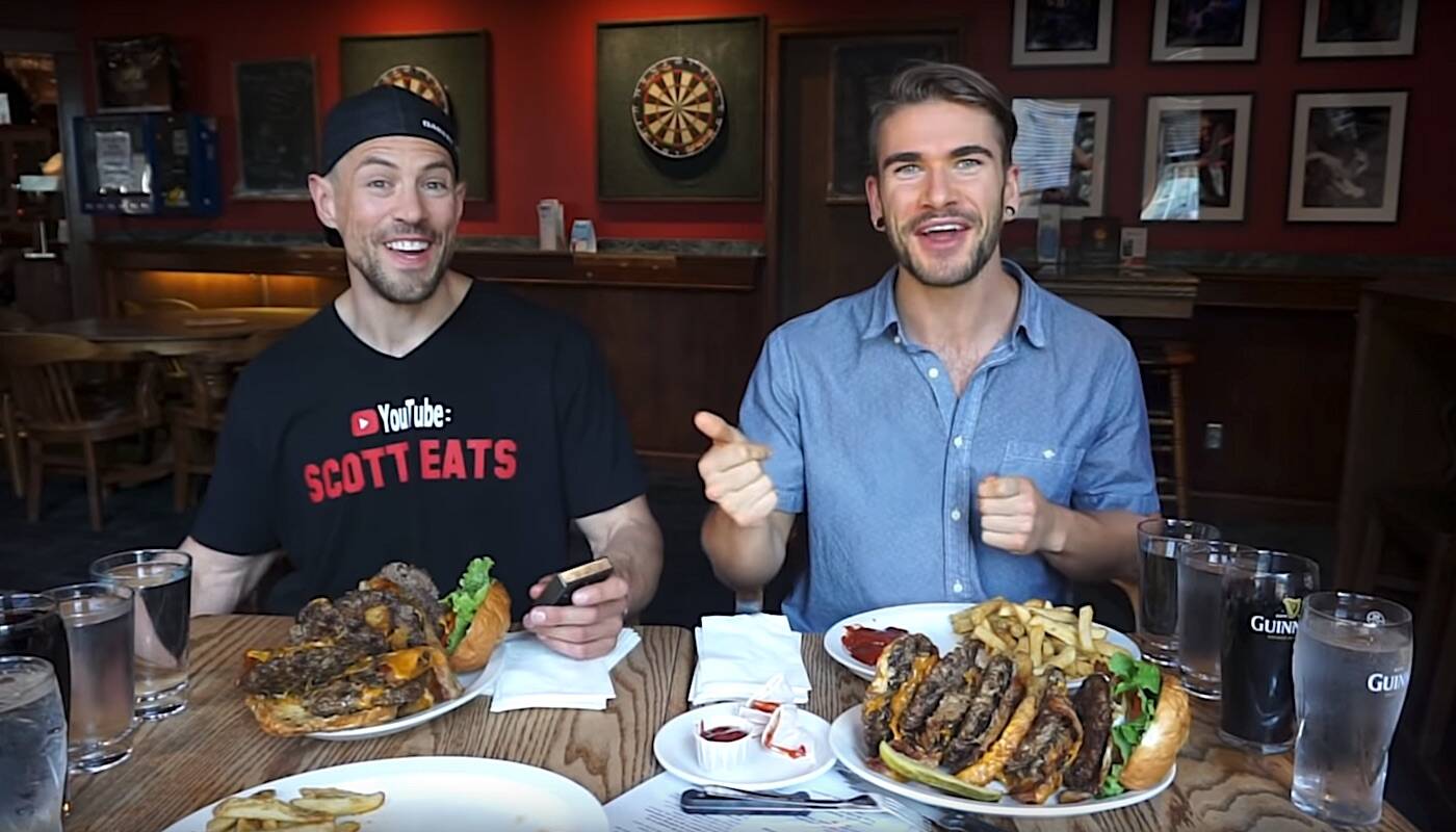 Competitive eaters Scott Eats, left, and Joel Hansen with the Blarney Stone Challenge burgers they ate at Donegals pub in Surrey, in video posted to Hansens YouTube channel in November 2020. (Youtube.com)