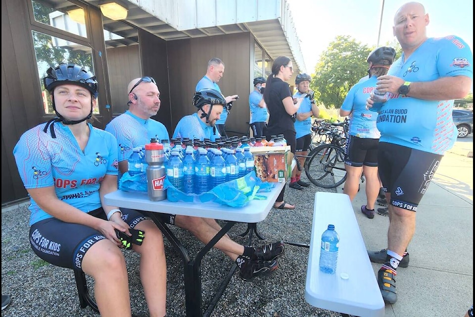 Members of the Cops for Kids cycle tour stopped at the Grand Forks Detachment on Saturday evening for a rest break and meet community members, including Const. Nick Reimann (second from left) of the Vernon-North Okanagan RCMP detachment, a veteran of the event. The group is fundraising to help children who are in medical, physical or traumatic crisis. The tour will arrive in Vernon Saturday, Sept. 16. Photo Karen McKinley