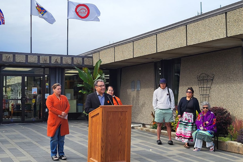 Okanagan Indian Band councillors Mary Jack (from left), Allan Louis, and Rochelle Saddleman are joined at Vernon City Hall by the OKIB's Kasey Miller, Danielle Saddleman, and elder Pauline Archachan as the band's flag (far right) now has a permanent home at Vernon City Hall. 