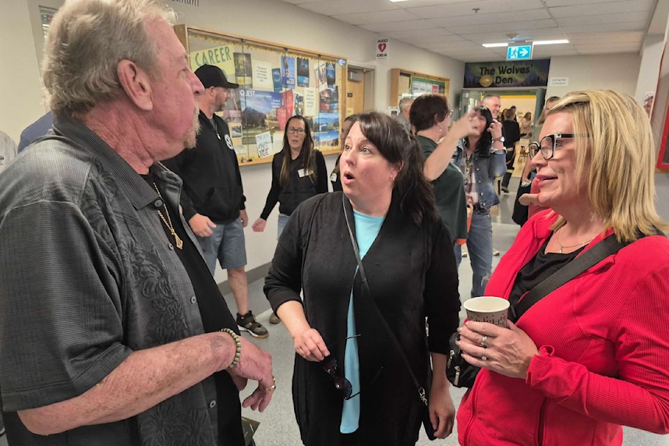 Former principal Rick Dedora (left) shares memories with former students Deana Albertson (née Forslund) and Sandi Matchett during the Charles Bloom Secondary School 75th anniversary celebrations Tuesday, April 29, in Lumby.