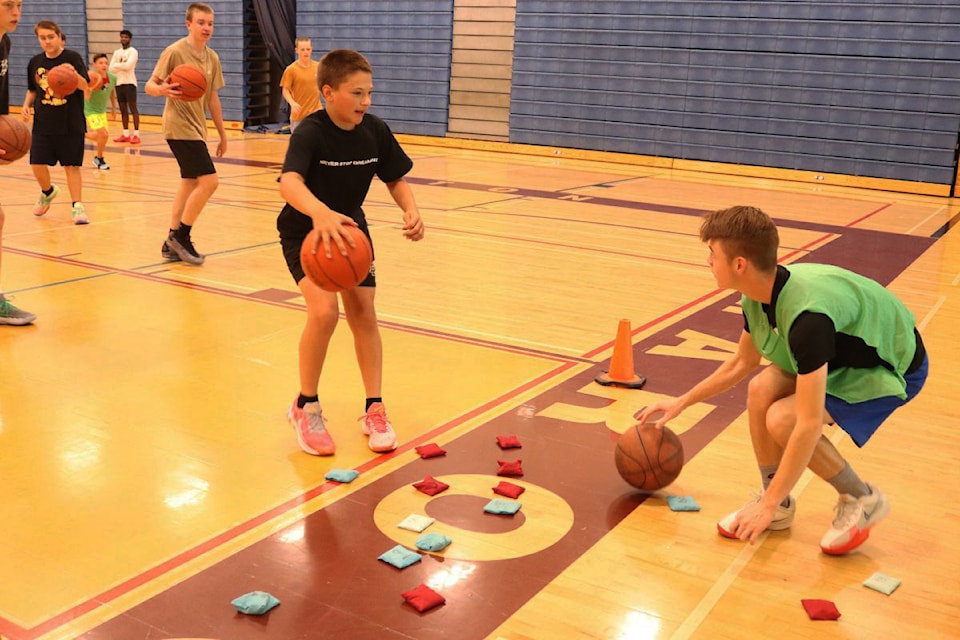 Camp participants had to keep dribbling while trying to steal the opposition's flag, or bean bag, during a fun drill at the 40th Hoops and Hustle Basketball Camp held the first week of July at Vernon's Fulton Secondary School.