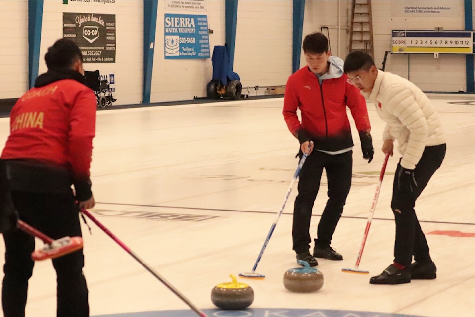 Team China skip Xiao Ming Xu (left) calls off sweepers Qiang Zou (red jacket) and Tianqi Guan during the men's final Monday, Oct. 7, of the Prestige Hotels and Resorts Curling Classic at the Vernon Curling Club.
