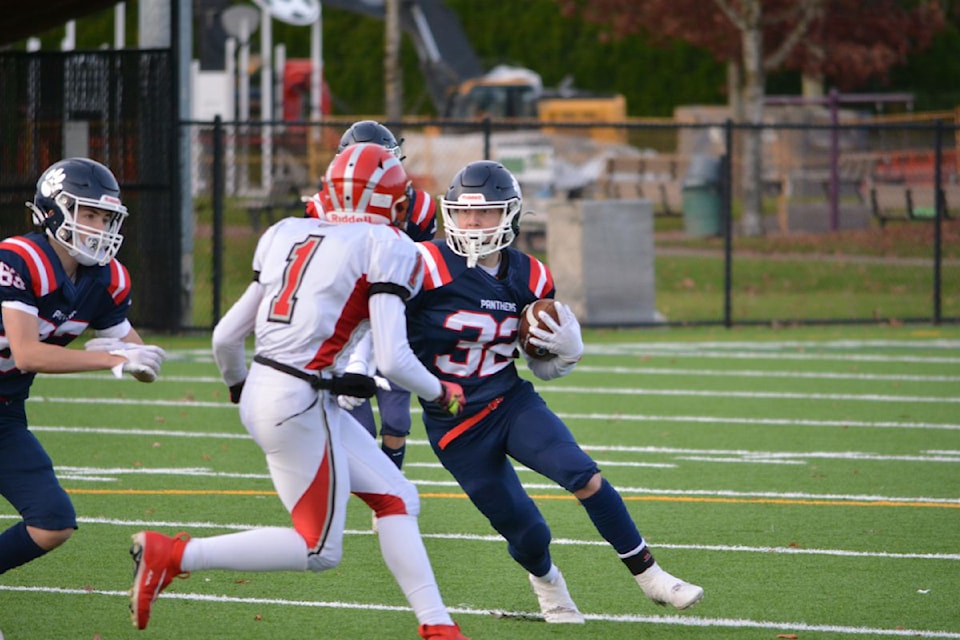 Vernon Panthers ball carrier Ayden Stringer (32) looks to cut back past the would-be tackle of John Barsby Bulldogs defender Kofi Lyle during B.C. High School Junior Varsity semifinal action Thursday, Nov. 21, in Chilliwack. Nanaimo's Bulldogs edged the defending B.C. champioin Panthers 16-14.