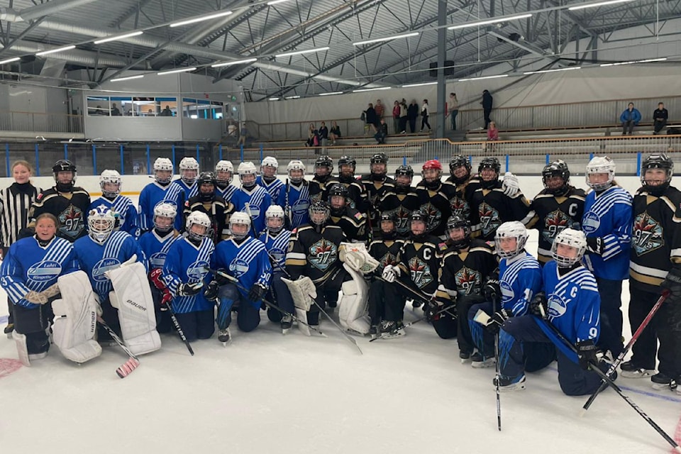 The Okanagan 97s ringette squad (black jerseys) gather for a post-game picture with Lahtii Ringette of Finland during an international U16 tournament in Helsinki, held Aug. 1-3.