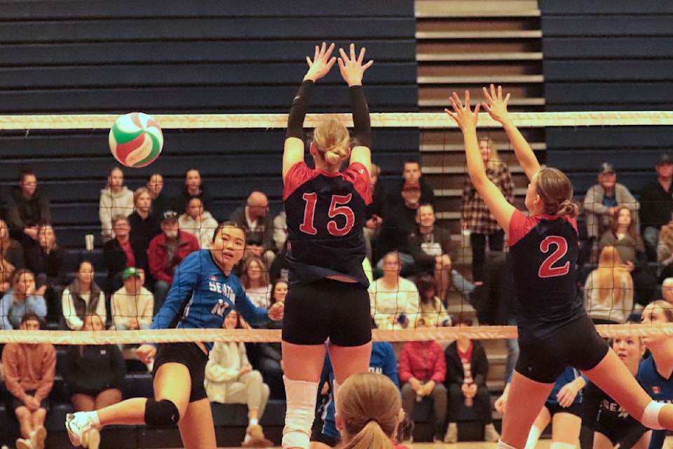 Seaton Sonics hitter Rie Shimizu (left) gets the ball past the Vernon Panthers double block of Devyn Hildebrand (15) and Paige Leahy during the Panthers' Interlock Senior Girls AAA high school volleyball tournament Friday, Oct. 25.