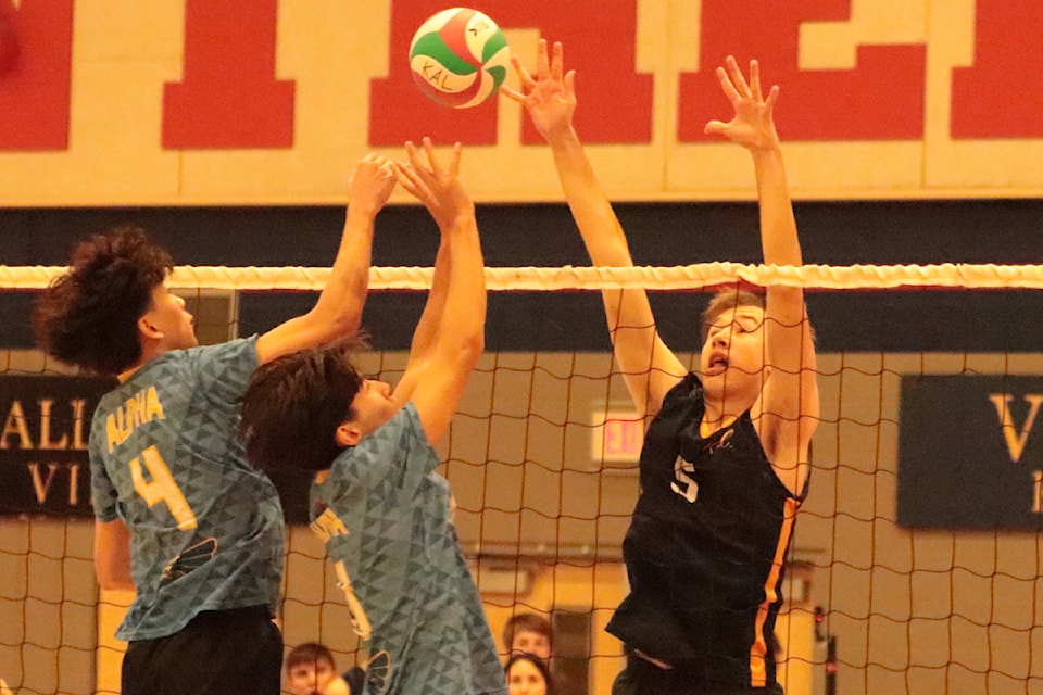 Kalamalka Lakers middle Jack Helfrick (5) takes on the double team of Lincoln Nguyen (4) and Steven Kim from Burnaby's Alpha Eagles during the Round of 16 playoffs Thursday, Nov. 28, at the B.C. Senior Boys AA High School Volleyball championships. Kal is hosting the 16-team tourney, but this game was played at Vernon Secondary.