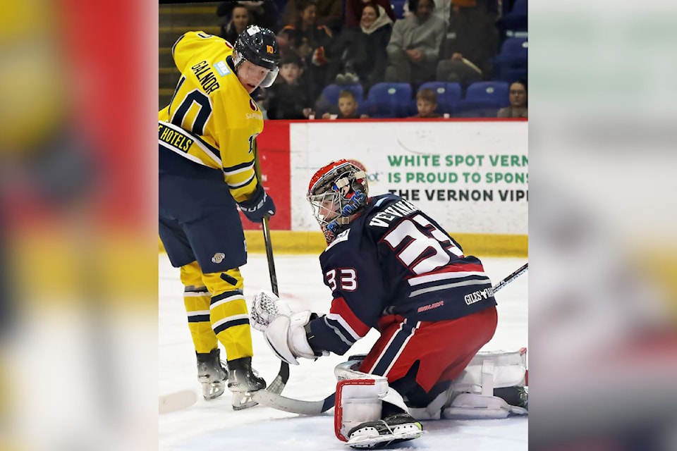 Vernon Vipers forward Jakub Galnor (left) and Brooks goalie Mikus Vecvanags keep their eyes on the puck during the Bandits' 6-3 BC Hockey League win Friday, Dec. 6, at Kal Tire Place. 