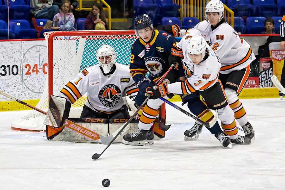 Vernon Vipers forward Simon Binckley (12) fights Trail defenders Max Hense (7) and Drew Anastasio (6) in front of goalie Ryan Parker during the Smoke Eaters' 5-4 B.C. Hockey League overtime win Saturday, Jan. 25, at Kal Tire Place. 