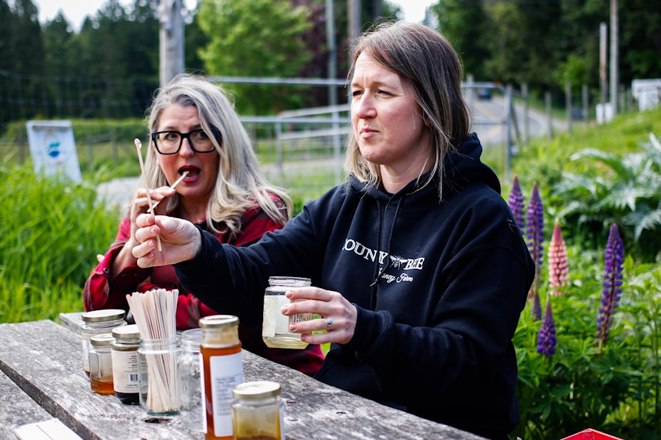 Minister of Agriculture and Food Lana Popham, left, got to taste some honey courtesy of Lindsay Dault of Country Bee Honey Farm
