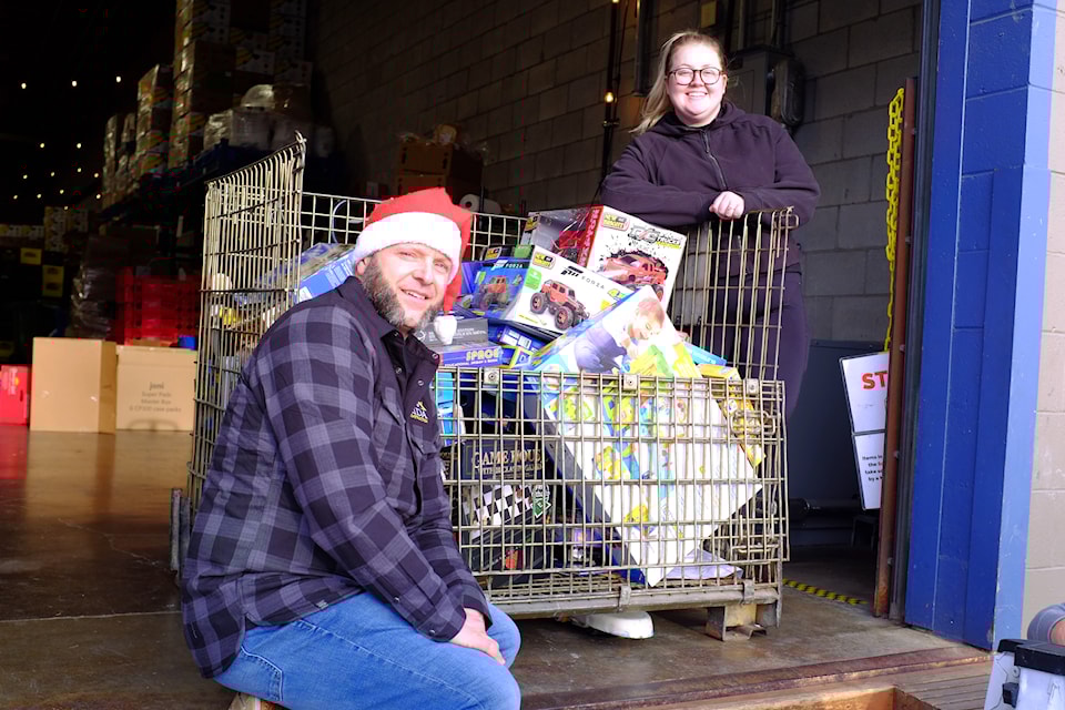 Terry Pearson (left) of LIDA Construction donated nearly 150 toys to the Mustard Seed ahead of the holiday season. 