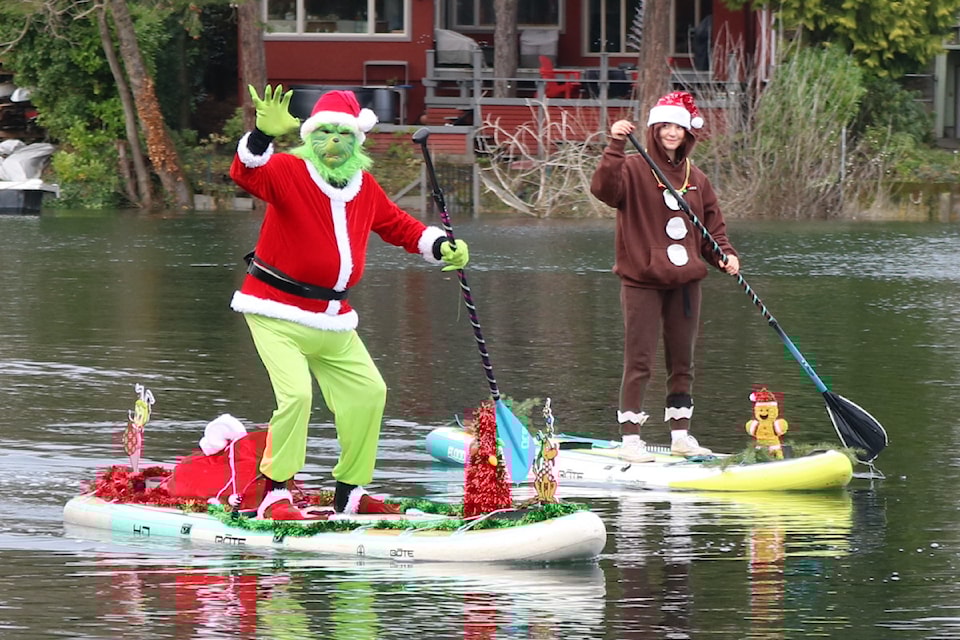 Curtis Becker, dressed as the Grinch, and his daughter Alyssa Becker, set off around the Gorge to spread holiday cheer.