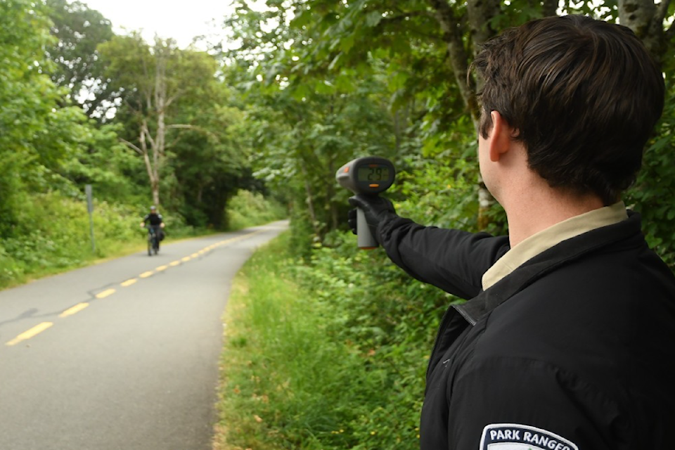 CRD park ranger checking a biker's speed