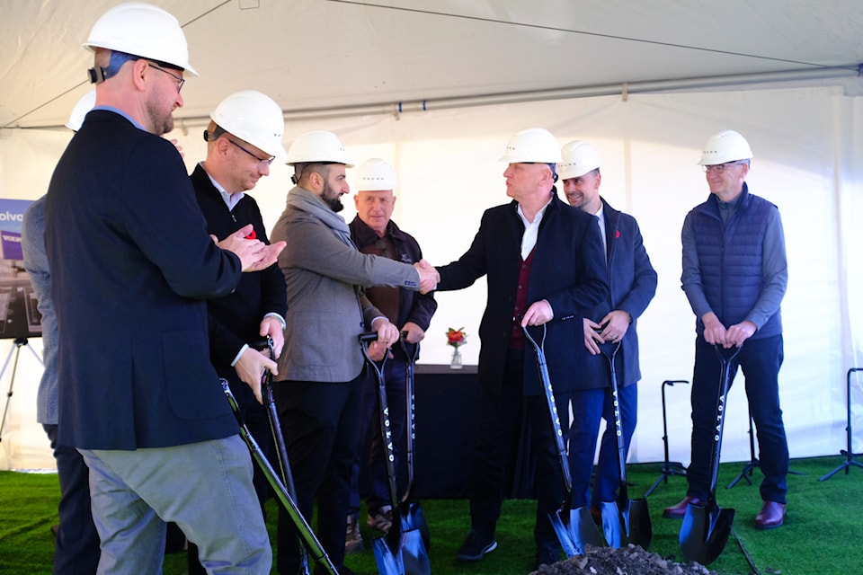 Peter Trzewik (right) shakes hands with Matt Girgis after shovelling the first dirt, marking the official groundbreaking of a new Volvo dealership in Victoria's Burnside Gorge neighbourhood. 