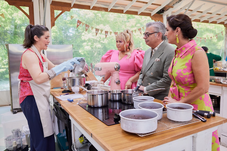 Contestant Jen Childs talks to host Ann Pornel (left) and judges Bruno Feldeisen and Kyla Kennaley on The Great Canadian Baking Show on CBC.