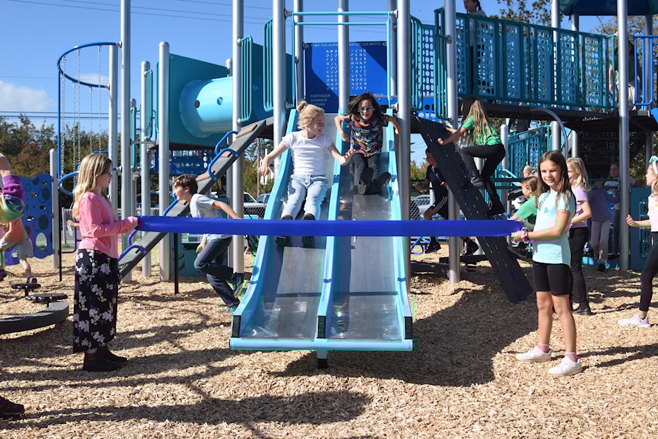 No ribbon-cutting, but a sliding to officially open the new playground at Deep Cove.