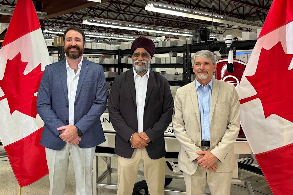Harjit Sajjan (middle), Canada's minister of emergency preparedness, who is also responsible for PacifiCan, made the funding announcement on Thursday, Sept. 5. Fritz Stahr, Open Ocean Robotics' 
chief technology officer stands to his left and Rob Pletscher, the company's manufacturing manager, to his right.