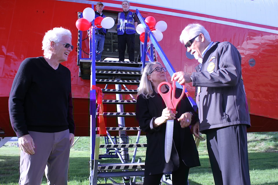 Tourism minister Lana Popham leads the ribbon-cutting ceremony with Wayne Coulson of Coulson Aviation and BCAM president, Steve Nichol.