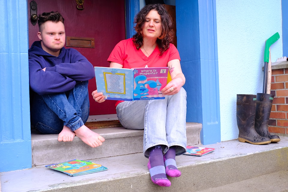 Benjamin Lohner, 21, sits with her mother, Tamara Hodgson, at their home in James Bay on April 9, 2025.
