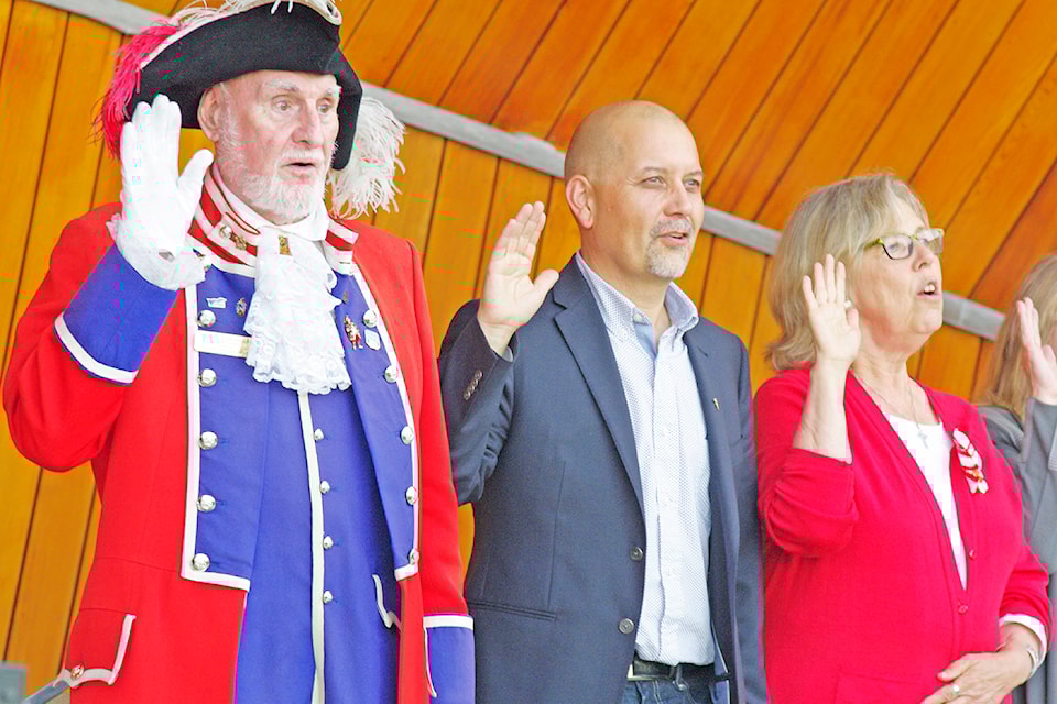Victoria Town Crier Bob Alexander, MLA Adam Olsen and MP Elizabeth May re-affirm their Canadian citizenship at Sidney's Canada 150 events in 2017.