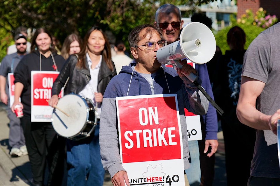 Harj Aheer, Vancouver Island representative for UNITE HERE Local 40, rallies Coast Victoria Hotel workers on Friday morning.