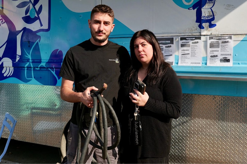 Eirini Sypsa-Kaya and her husband, Vedat Kaya, hold the heavy-duty professionally made power cord which was sliced through. 