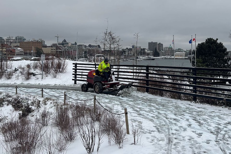 The E&N Trail and sidewalks at the Johnson Street Bridge are cleared of snow by a plow.