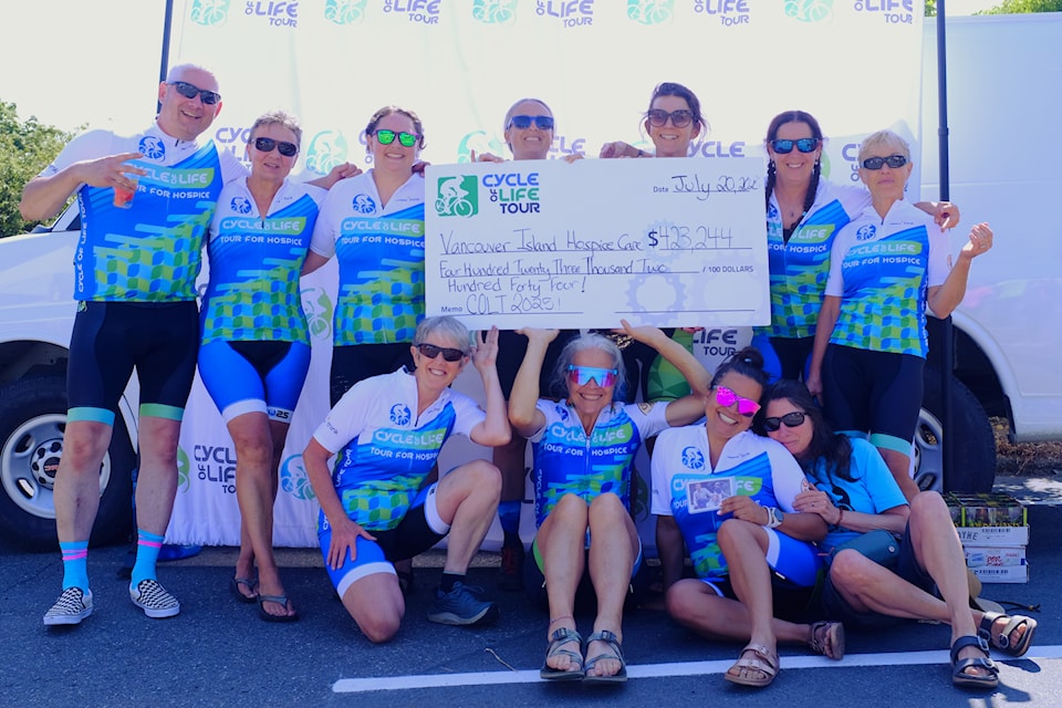 A few riders pose with a cheque after finishing the 2025 Cycle of Life.