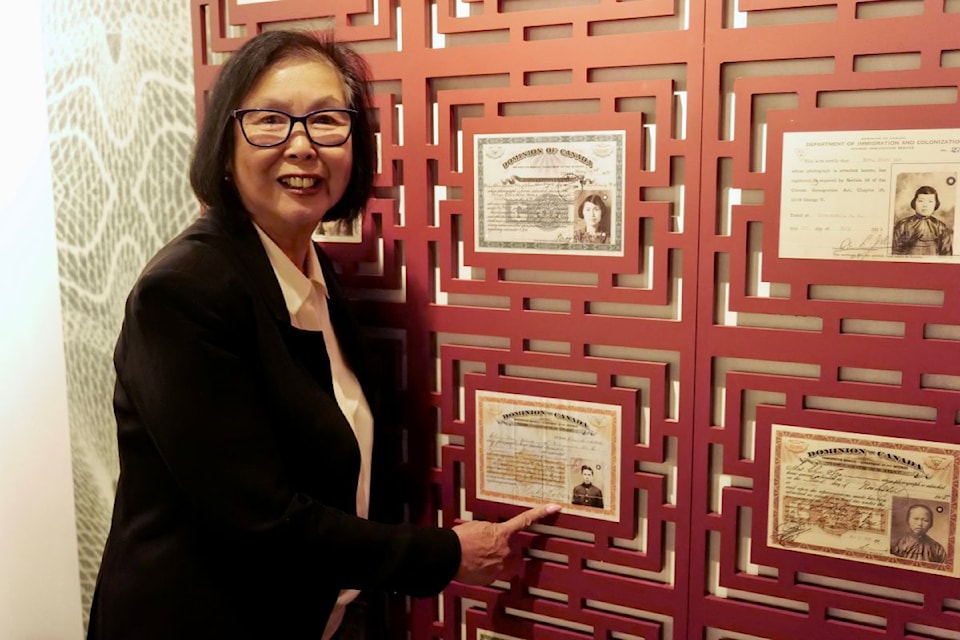 Grace Wong Sneddon points to a photo of her father, who immigrated to Canada as a 14-year-old in 1905.