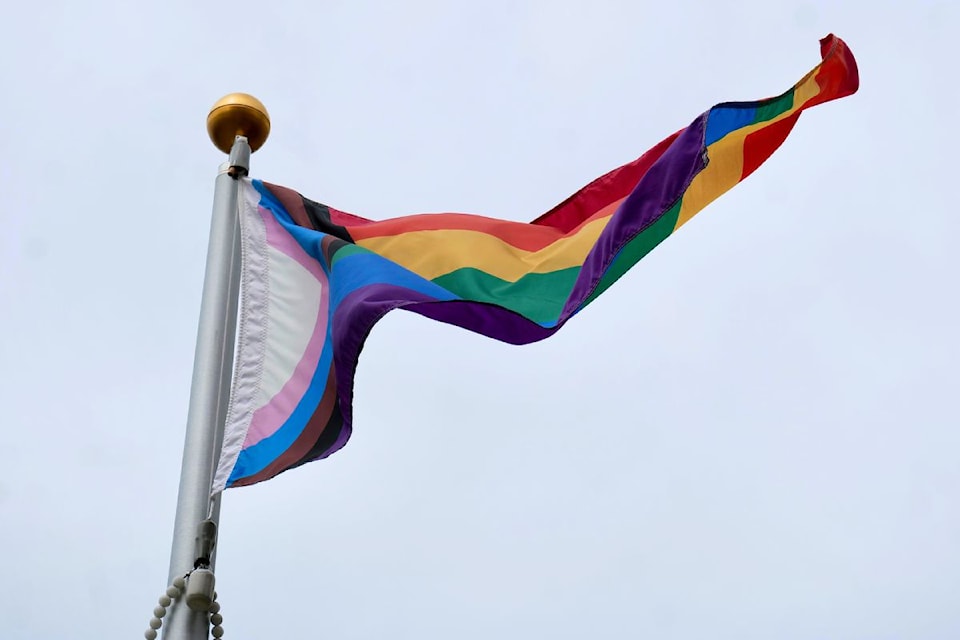 The Progress Pride flag flies above Victoria City Hall following a ceremonial raising on Friday, June 27.