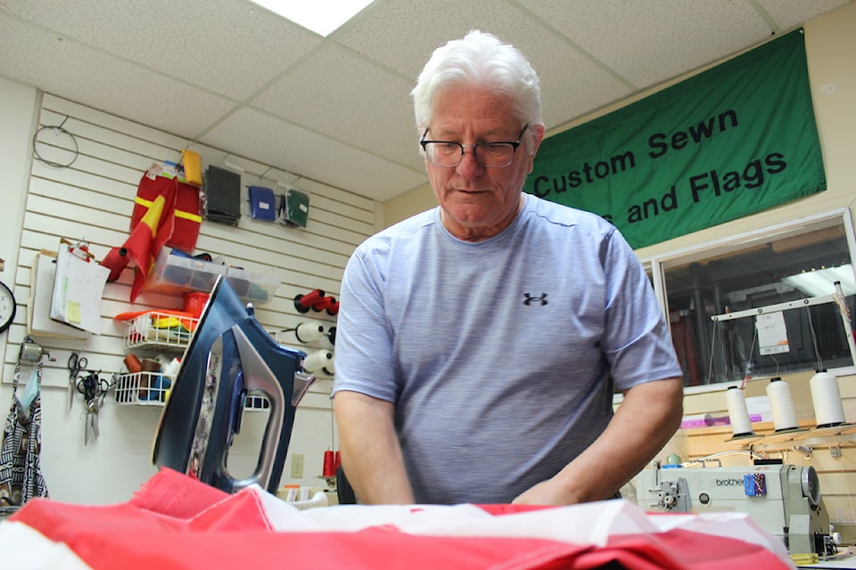 Flag Shop Victoria owner Paul Servos demonstrates how the business crafts custom flags.