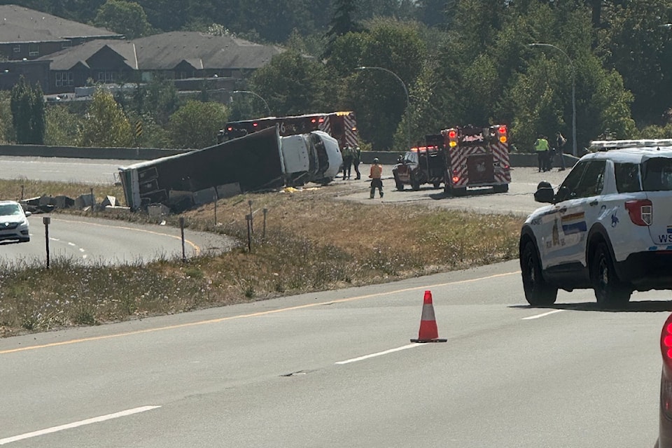 A crashed truck is seen tipped on its side as the incident shut down the Trans Canada Highway lanes in Greater Victoria on Aug. 8.