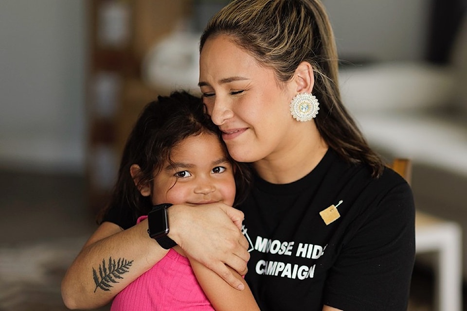 The Moose Hide Campaign's co-founder Raven Lacerte embraces her daughter Cedar at their Victoria home. 
