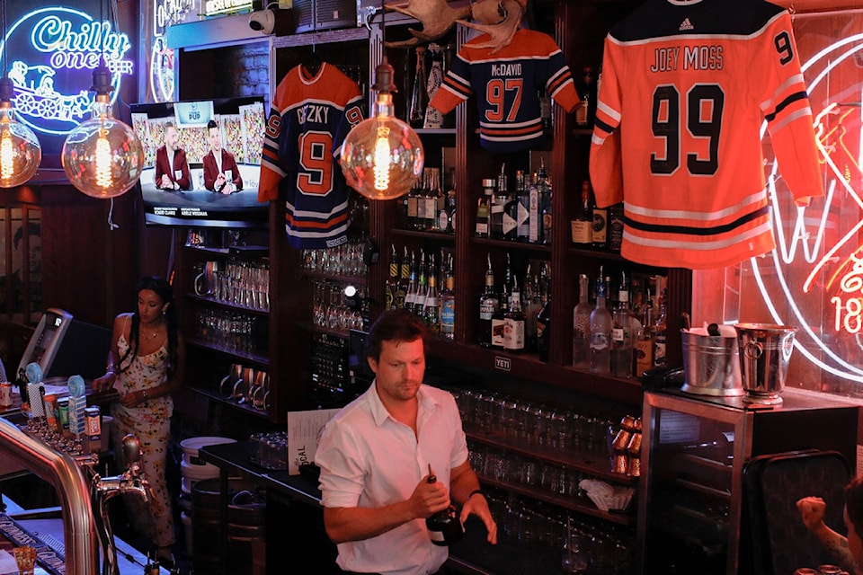 Jerseys belonging to Connor McDavid, Wayne Gretzky, and beloved locker room attendant Joey Moss hang on the walls of The Local.