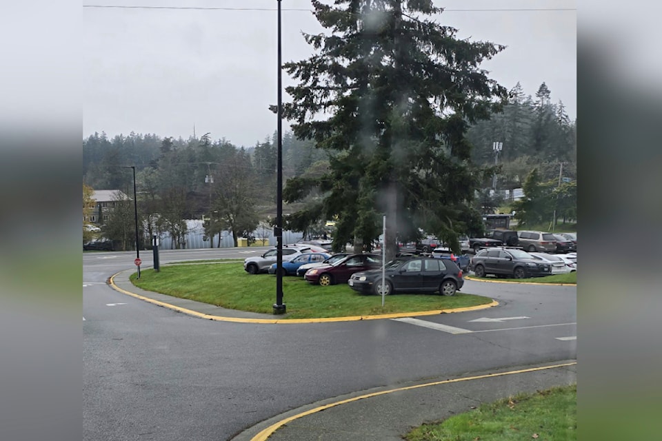 Photo taken at Camosun College's Interurban Campus where students are illegally parked of the school's lawn.