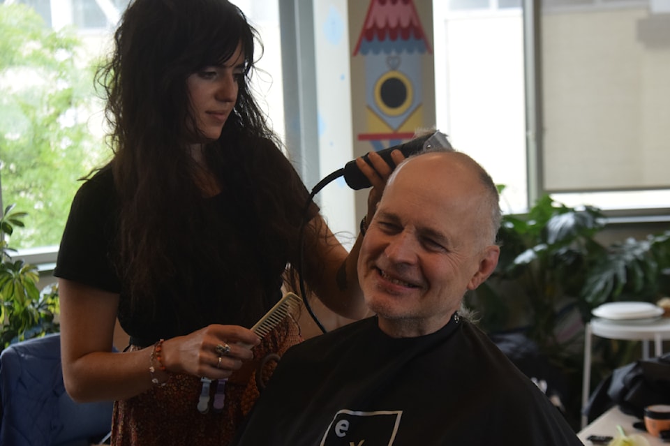 Handsome men get hair cuts at Our Place Society in Victoria