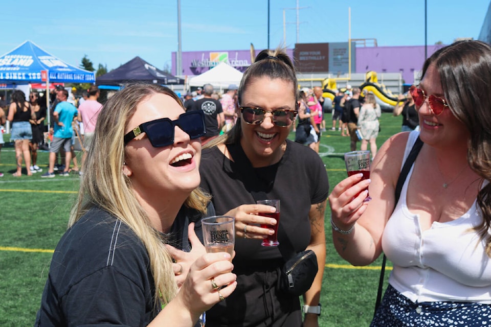 Carly Davis, Danielle Weslosky and Lauren Murphy enjoy their beer at the second annual Langford Beer Fest on Saturday (July 15). (Bailey Moreton/News Staff) 
