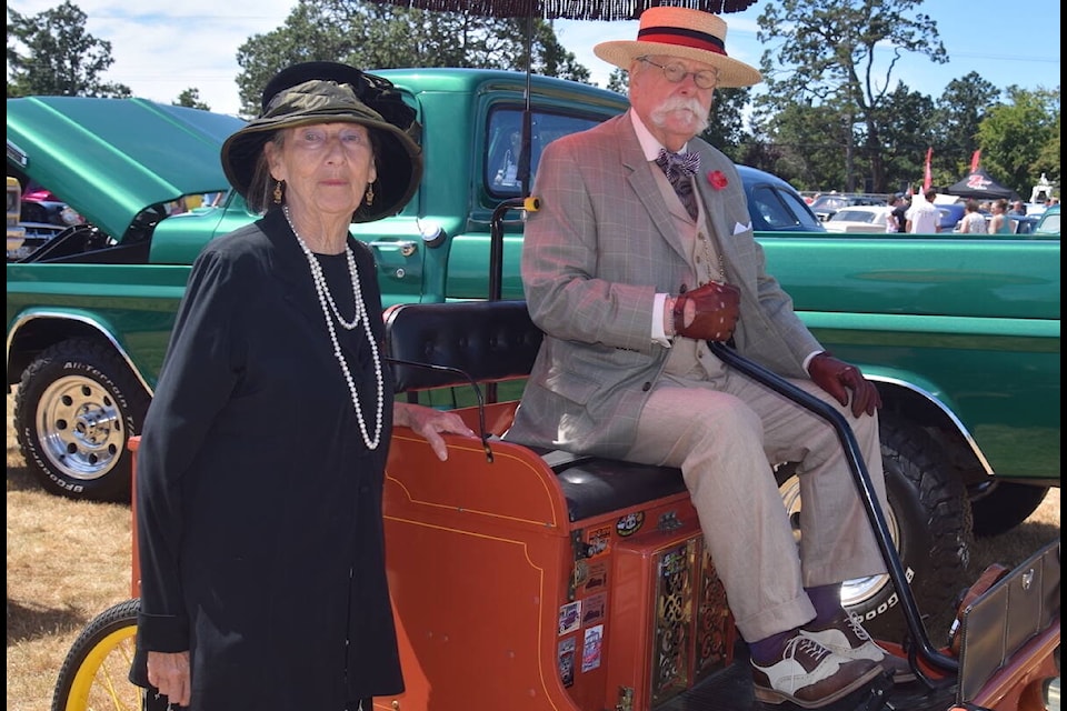 Gary and Sybil Gangas show off their recreation 1903 Waverley Electric during the 2023 Fords and Friends car show Sunday (July 16). (Brendan Mayer/News Staff) 