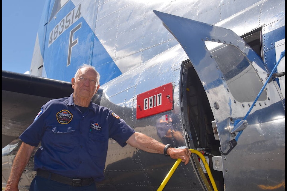 Ground support services and ride event coordinator Larry Sheets helps Victoria Flying Club visitors exit the B-17 bomber Sunday (July 30). (Brendan Mayer/News Staff) 