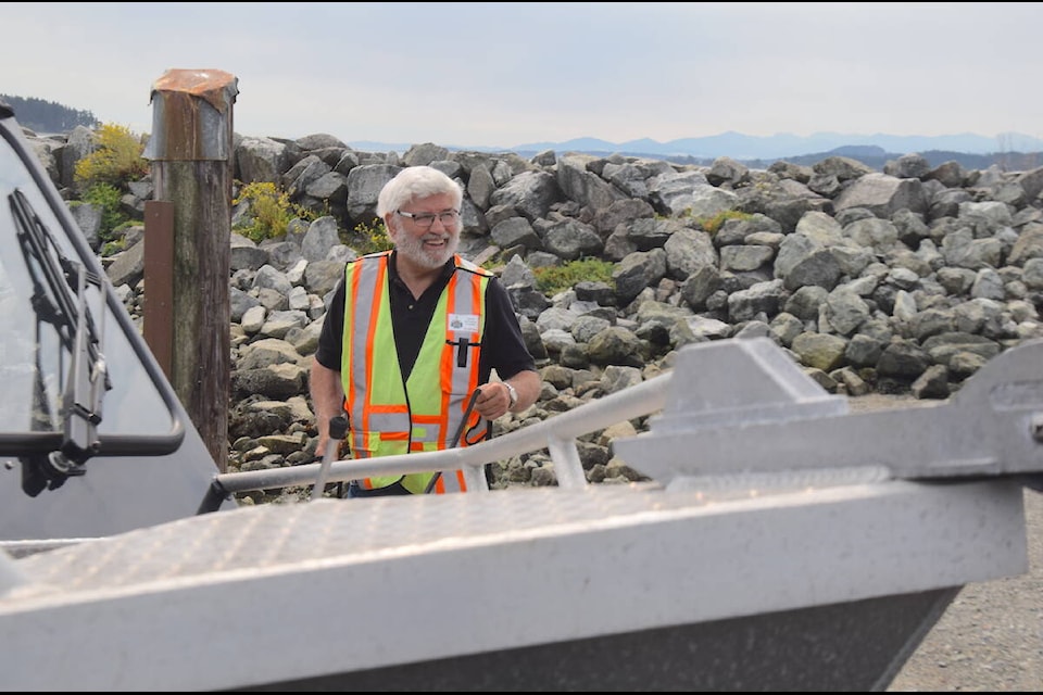 Volunteers with the Sidney Anglers Association, including Norman Kent, help people at the Tulista Park boat launch on weekends throughout the summer. (Brendan Mayer/News Staff) 
