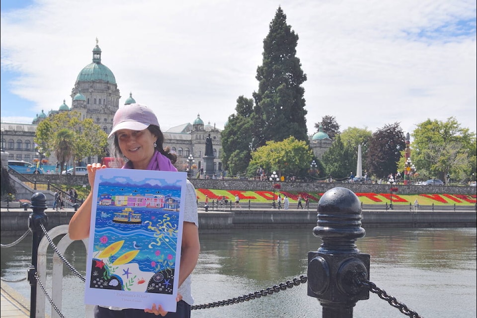 Gloria Kasek holds her folk art of Fisherman’s Wharf on Victoria’s Inner Harbour Tuesday (Aug. 8). (Brendan Mayer/News Staff) 